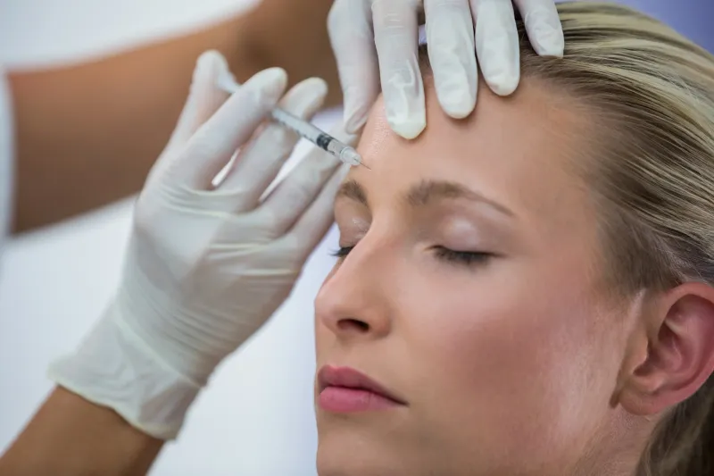 A neurotoxin (Botox) treatment being administered to the forehead area
