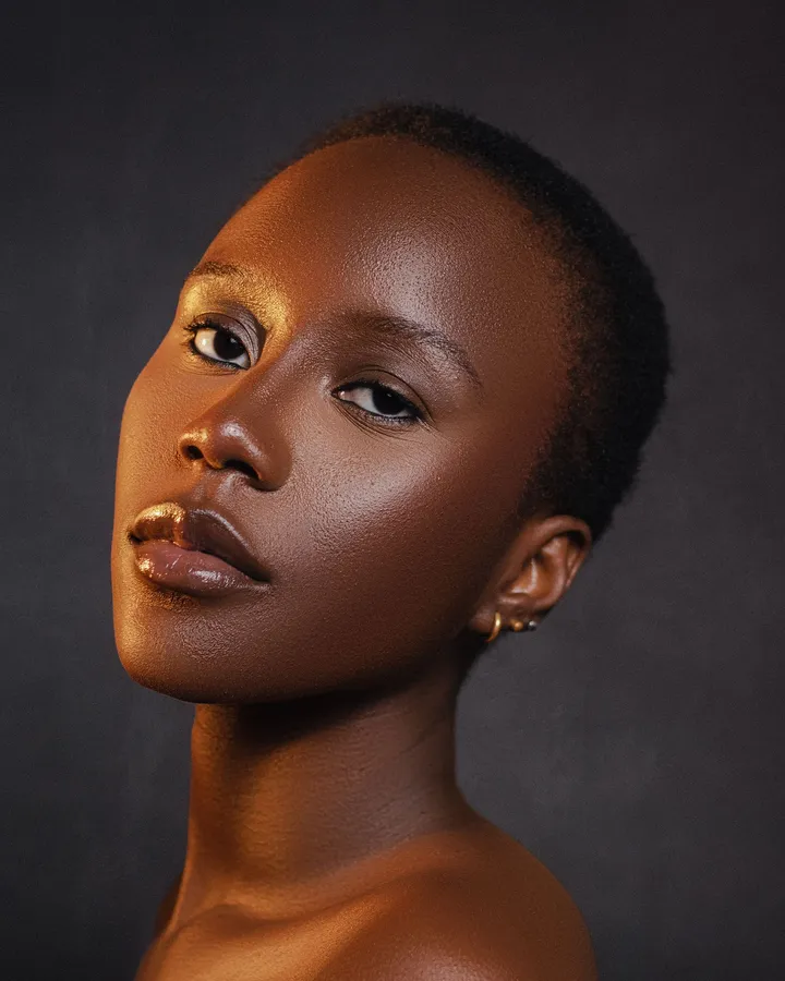 Close-up portrait of a woman with lifted, glowing cheeks