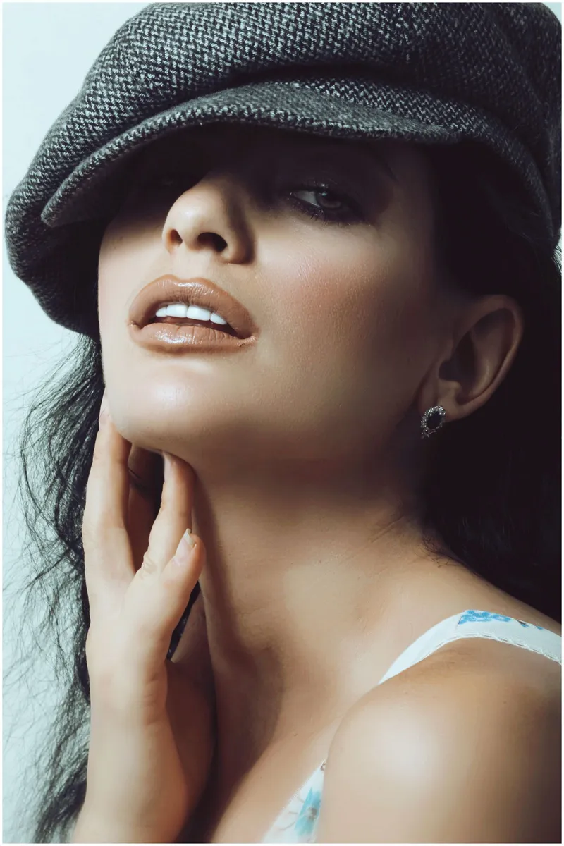 A woman with her hand at her jawline, showing the chin and jaw profile